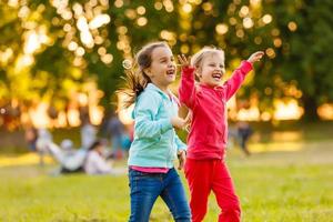 Summer fun. little girls play in the field photo