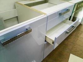 Opened kitchen drawer with plates inside, a smart solution for kitchen storage and organizing. photo