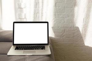 The laptop and computer in the morning on a white pillow bed. Lifestyle Concept photo