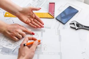 Hands of Engineer working on blueprint,Construction concept. Engineering tools.Vintage tone retro filter effect,soft focus photo