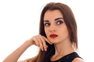 portrait of charming young woman with red lips with her hands near face and looking away isolated on white background photo