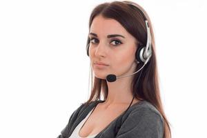 close up of young serious call center woman woman with headphones and microphone isolated on white background photo