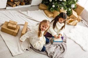 christmas, x-mas, winter, happiness concept - two adorable girls playing photo