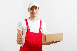 Portrait of happy worker unloading boxes from a delivery van and looking at camera photo