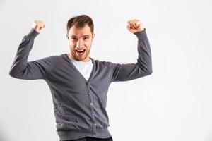 Young man presenting your product, isolated over a white background photo