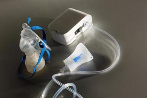 Compressor nebulizer with mask on table photo