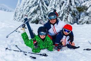 Group of friends with ski on winter holidays - Skiers having fun on the snow photo