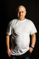 Portrait of an elderly man on black background photo