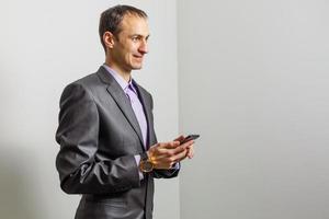 sonriente joven hombre de oriente medio con smartphone foto