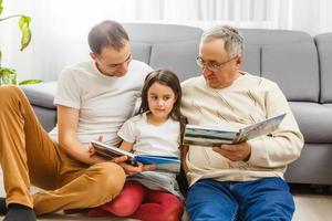 father, son and granddaughter at home photo