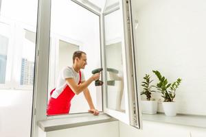 Carpenter repairing window frames, home is being updated to be sold photo