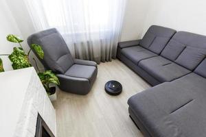 Robotic vacuum cleaner cleaning the room photo