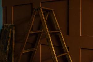 Old stepladder in an abandoned house. Repairs. photo