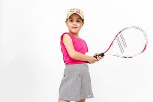 Cute little girl with tennis racket in her hands on white background photo