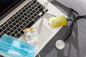 Pills spilled over a keyboard of a laptop computer photo