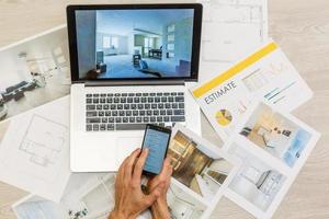 top view of Designer hand working with laptop computer on wooden desk as responsive web design concept photo