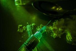 Close-up of vaccine drop on syringe needle photo