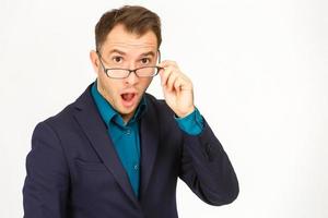 A view of a shocked young businessman isolated on white background photo