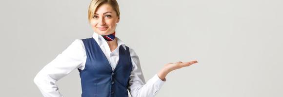 Portrait of charming stewardess wearing in blue uniform. Isolated on white background photo