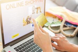 Young Woman On Sofa Shopping Online With Debit Card photo