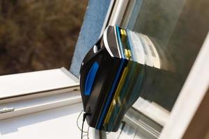 Detail of a glass cleaning robots acting behind a window photo