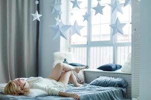 Portrait of a pretty woman relaxing in bed photo