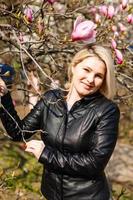 Woman in front of sakura spring blossoms photo