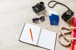 Flat lay traveler accessories on yellow background with blank space for text. Top view travel or vacation concept. Summer background photo