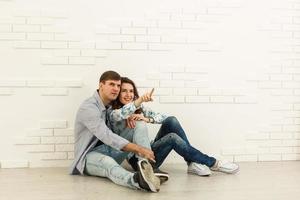 Happy young couple moving in their new apartment photo