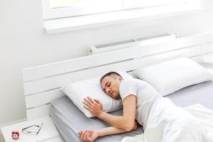 Picture showing young man sleeping in bed photo