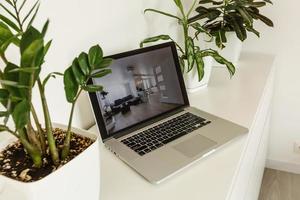 office tabletop with tablet, laptop showing cool hotel responsive design website photo