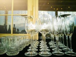 Wine glasses in row on bar photo