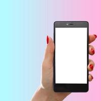 hold and show smart phone by woman beauty right hand with pink pastel background photo