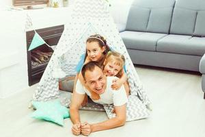 Dad is her best friend. Father and daughter looking at each other and smiling while lying on the floor in bedroom photo