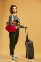 beautiful slim girl and straw hat posing with baggage and passport, isolated photo