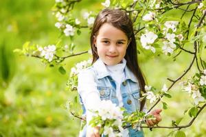 Beautiful girl in flowering Apple trees. Long hair photo
