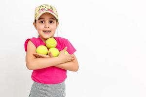 Brunette little girl with a tennis racket isolated on a over white background photo