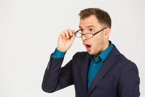 A view of a shocked young businessman isolated on white background photo