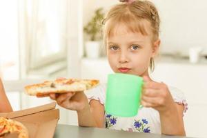 holding pizza - having fun eating dinner - Rebel concept - Focus on left slice photo