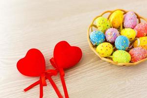 Easter eggs with tulips in heart shell on blue wooden background