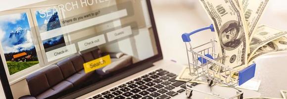 Small shopping cart with Laptop for shopping online concept.selective focus photo
