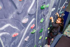 Little Girl Climbing Rock Wall photo