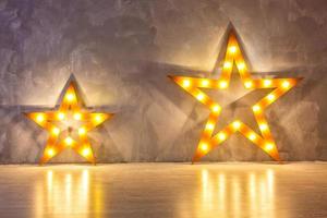 Decorative star with lamps on a background of wall. Modern grungy interior photo