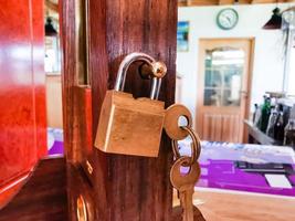 Old rusty padlock on wooden background photo