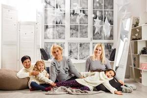 happy young family holding christmas gift and smiling photo