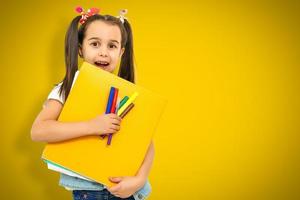 funny child school girl girl on yellow background photo