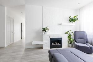 Modern living room with fireplace, sofa, balcony and pattern carpet photo