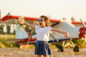 sweet little girl near the plane photo