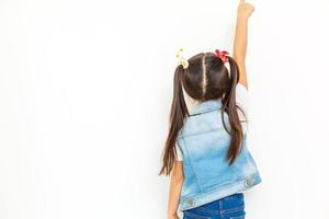 Little baby girl showing something above her, rear view white background photo