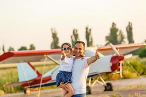 dad and 7 year old child playing plane photo